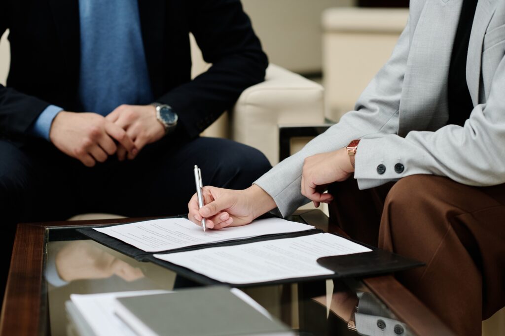 Businesswoman signing contract at meeting